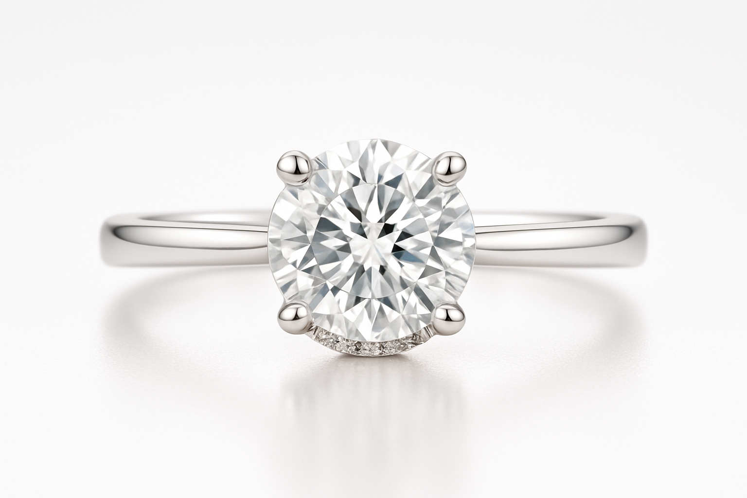 white gold engagement ring with a round center diamond with a hidden halo on a white background. be sure to make the center look straight ahead